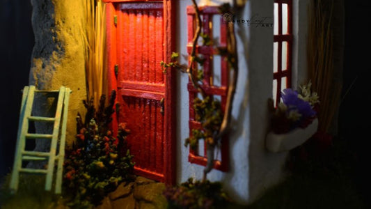 Irish cottage miniature diorama with red door and warm lighting. Irish cottage in a glass dome — example of how color, texture, and lighting create a believable miniature scene.