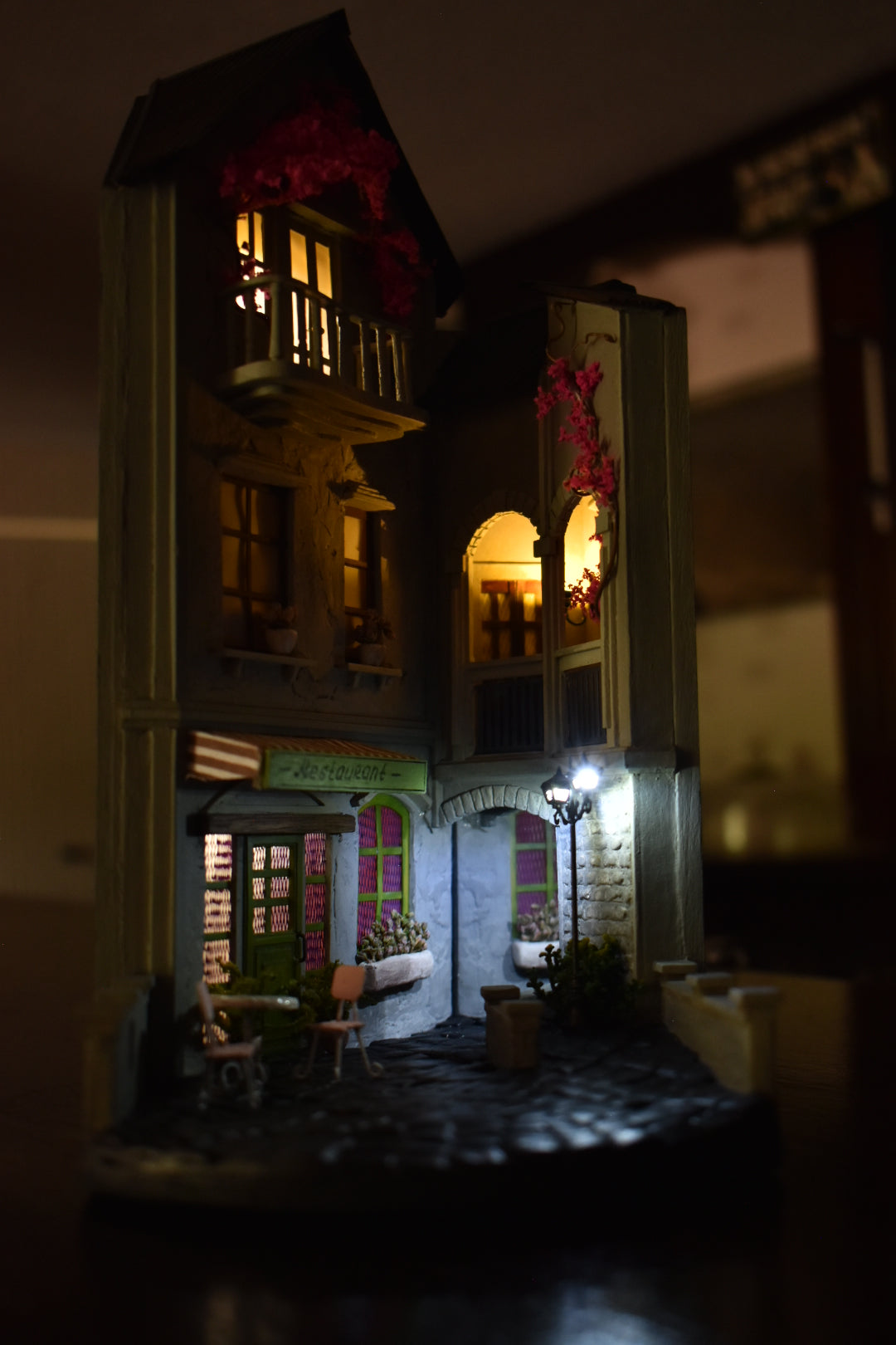 Book nook insert HandiCraftArt depicting a cosy French restaurant, creating an atmosphere of Parisian charm and romance. It features built-in lighting and a mirror effect.