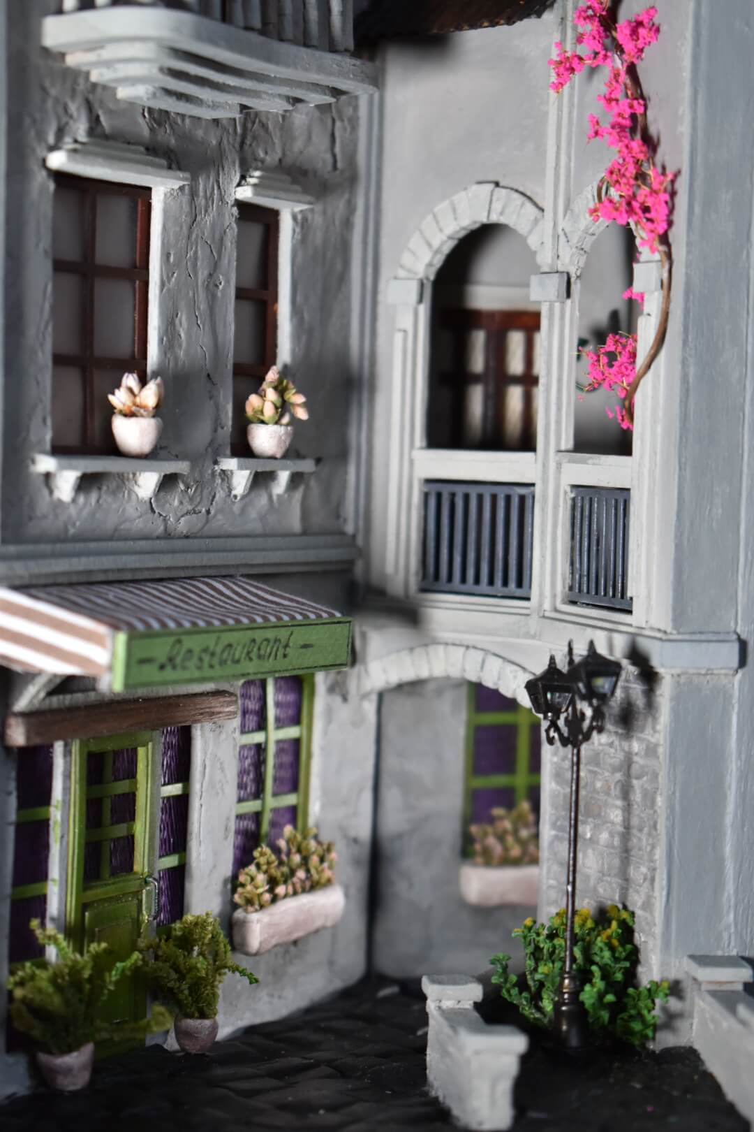 Book nook insert HandiCraftArt depicting a cosy French restaurant, creating an atmosphere of Parisian charm and romance. It features built-in lighting and a mirror effect.
