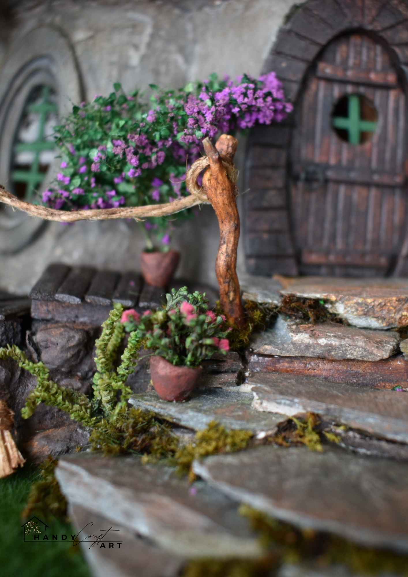 Miniature garden scene with stone pathway, plants, and a fairy door. Fantasy diorama tree house by HandicraftArtie
