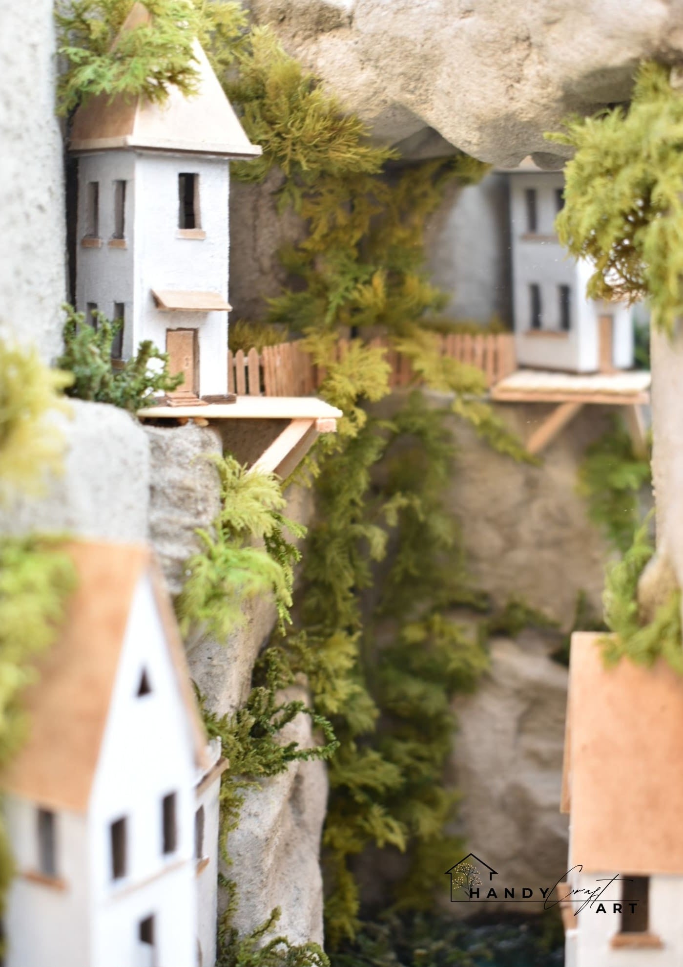 Miniature Concept Book nook of a White city on the cliffs with houses and plants 
