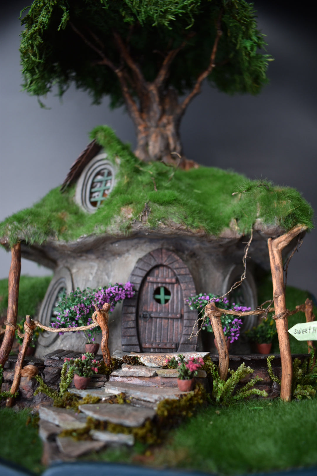 Diorama Treehouse with vibrant grass and charming oval windows, nestled under the sprawling canopy of a tree. Totally  handmade by HandiCraftArt.