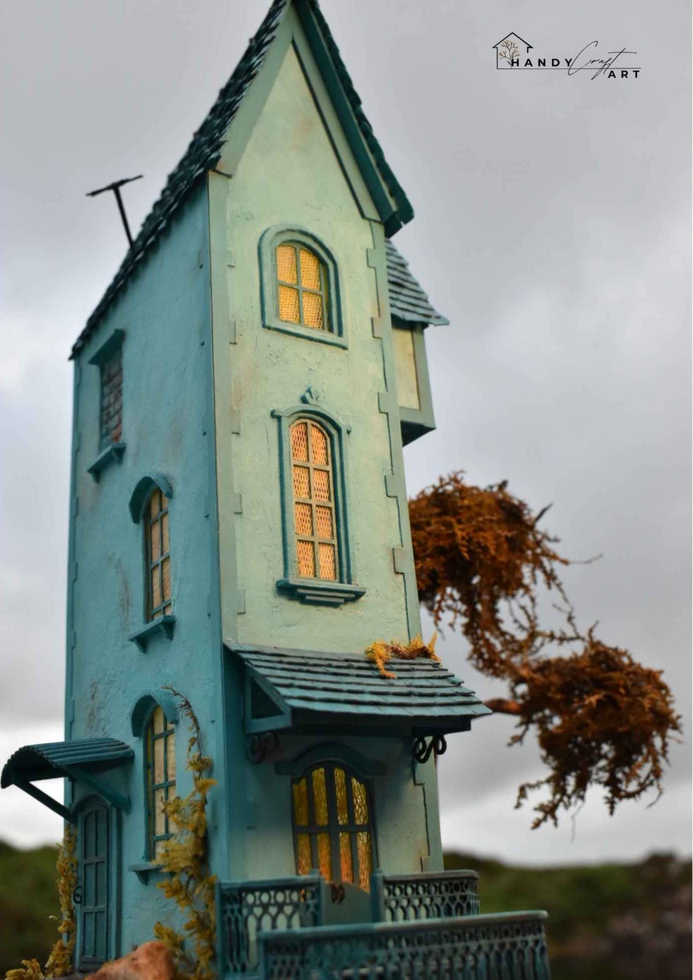 Collectible handmade diorama book nook style by HandiCraftArtIE. Teal dollhouse with ornate windows.