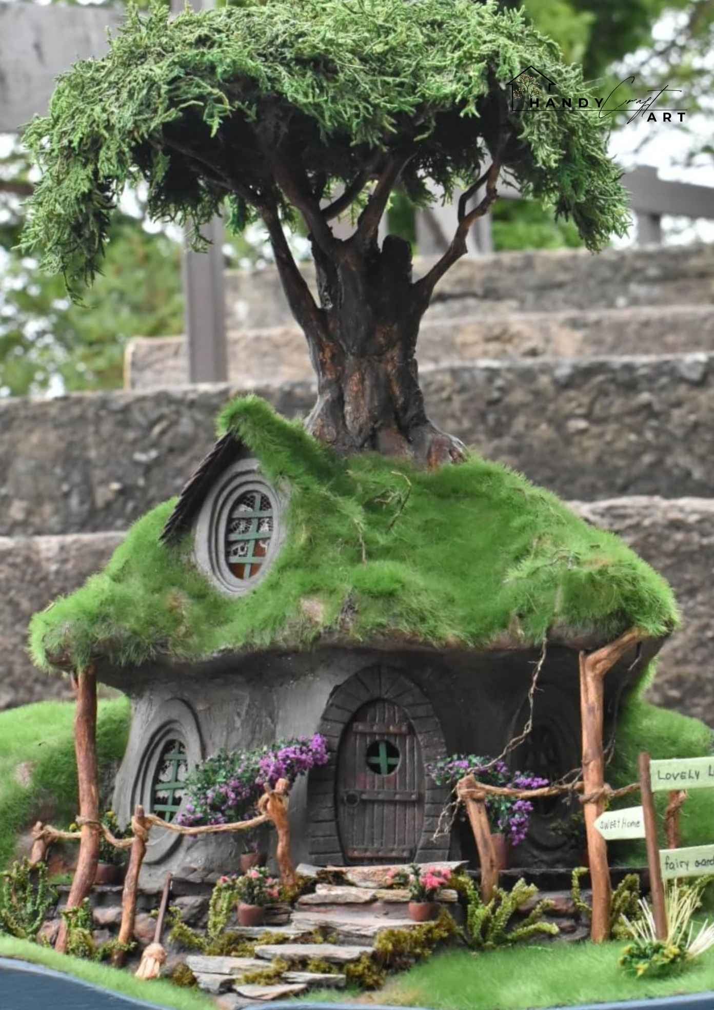 Handmade fantasy diorama tree house by HandicraftArtie. Miniature fairy house, surrounded by plants and flowers.