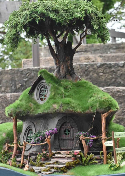 Handmade fantasy diorama tree house by HandicraftArtie. Miniature fairy house, surrounded by plants and flowers.