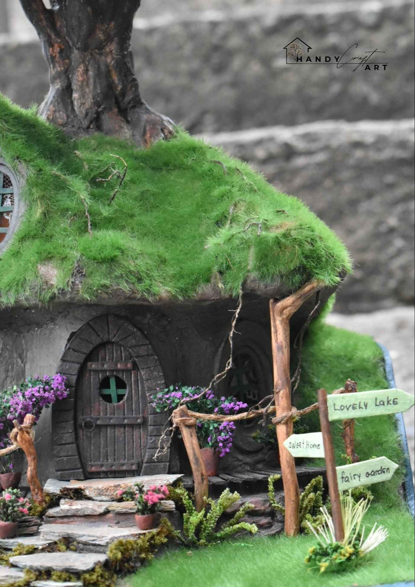 Gnome house with green roof and stone pathway. Miniature fantasy diorama of a tree house with whimsical forest scene by HandicraftArtie.
